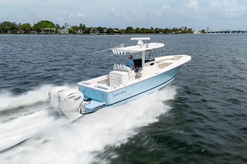 Slide: The Image of 2026 Regulator 31 boat cruising on water with twin Yamaha engines. - 13