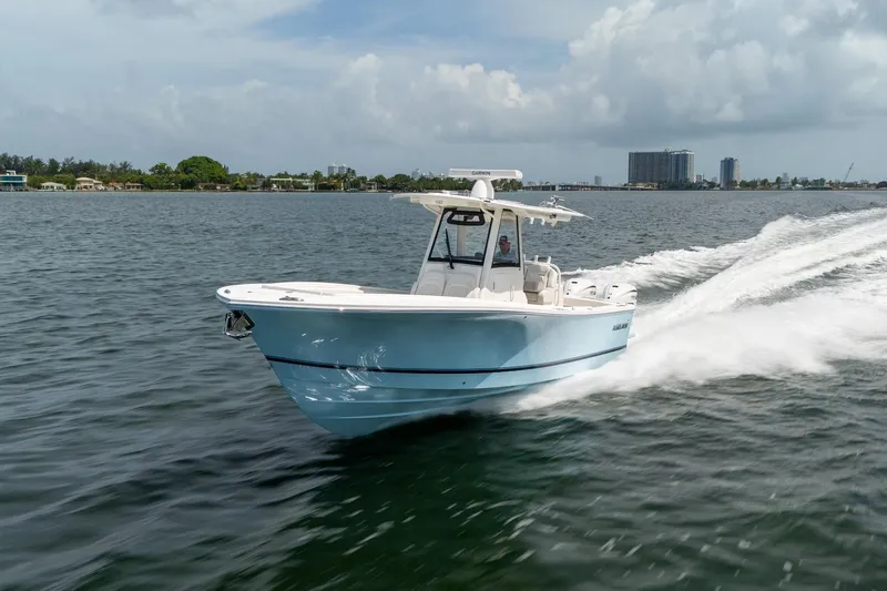 Slide: The Image of 2026 Regulator 31 boat cruising on open water under a cloudy sky. - 14