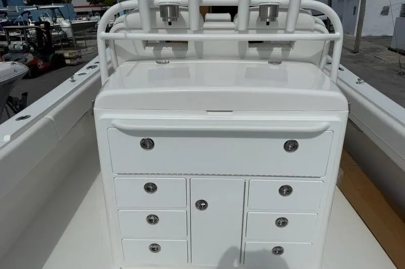 Slide: The Image of 2026 Regulator 31 boat console with multiple storage compartments and rod holders. - 15