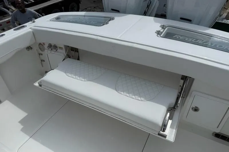 Slide: The Image of 2026 Regulator 31 boat with fold-out seating and storage compartment. - 17