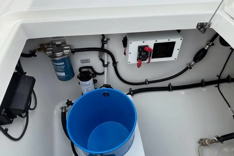Slide: The Image of Interior view of a 2026 Regulator 31 boat compartment with equipment and blue bucket. - 18