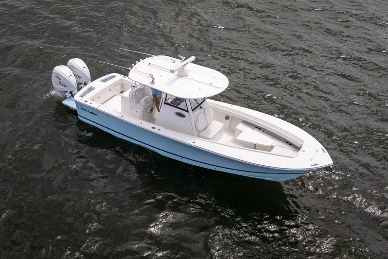 Slide: The Image of 2026 Regulator 31 boat with dual engines cruising on open water. - 2