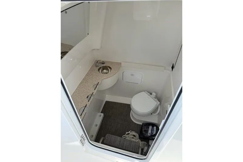 Slide: The Image of 2026 Regulator 31 boat interior with compact bathroom, sink, and toilet. - 20