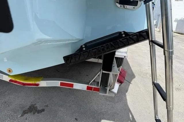 Slide: The Image of 2026 Regulator 31 boat on trailer, featuring a ladder and trim tab. - 23