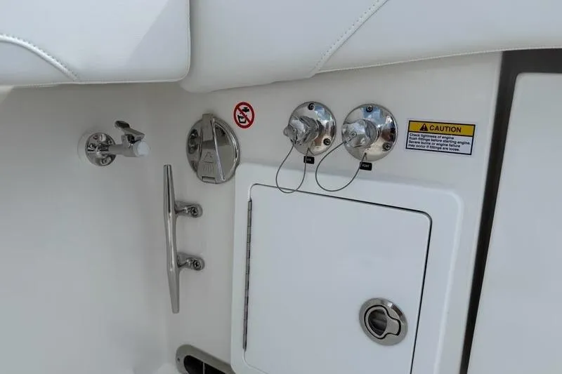 Slide: The Image of 2026 Regulator 31 boat fuel and water access panel with caution label. - 28