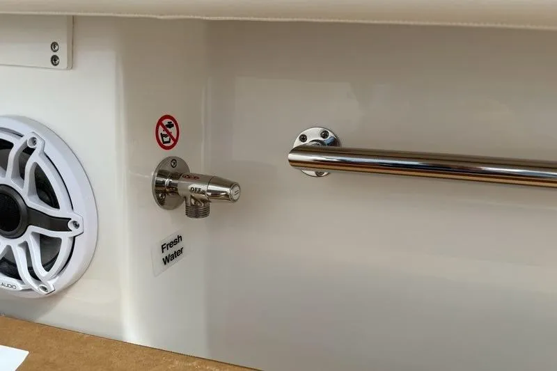 Slide: The Image of 2026 Regulator 31 boat interior with speaker, fresh water tap, and metal handle. - 29