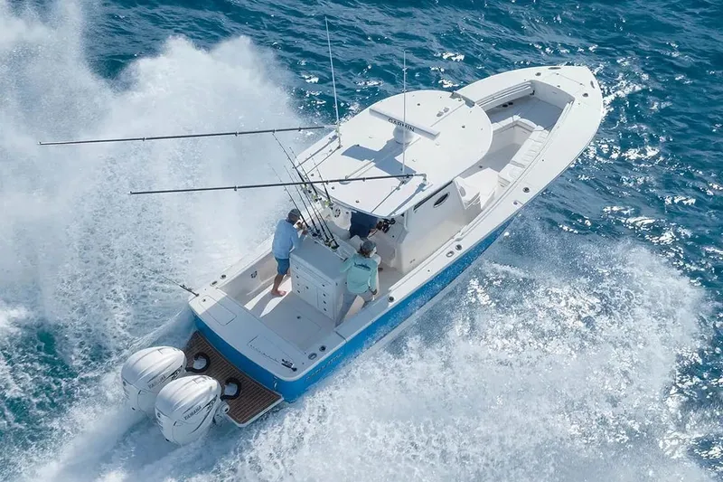 Slide: The Image of Manufacturer Provided Image: 2026 Regulator 31 boat cruising on ocean with dual engines and fishing rods. - 33