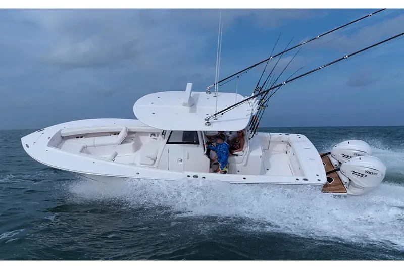 Slide: The Image of Manufacturer Provided Image: 2026 Regulator 31 boat cruising on open water with fishing rods and twin Yamaha engines. - 34