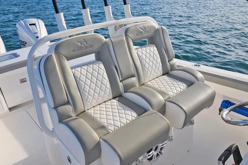 Slide: The Image of Manufacturer Provided Image: Luxurious seating on 2026 Regulator 31 boat with quilted upholstery, ocean backdrop. - 35