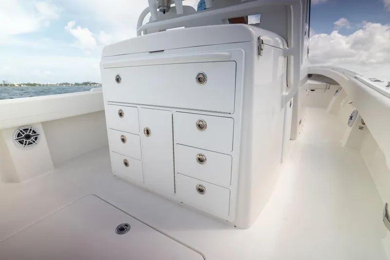 Slide: The Image of 2026 Regulator 31 boat interior with storage compartments, sleek design, and ocean backdrop. - 6