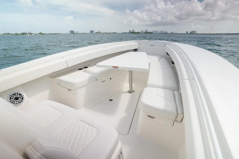 Slide: The Image of Luxurious 2026 Regulator 31 boat interior with white seating and table on open water. - 7