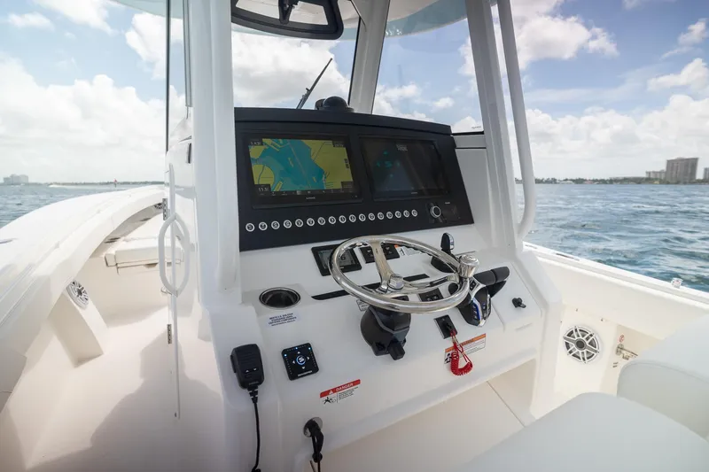 Slide: The Image of 2026 Regulator 31 boat cockpit with advanced navigation system and steering wheel on open water. - 9