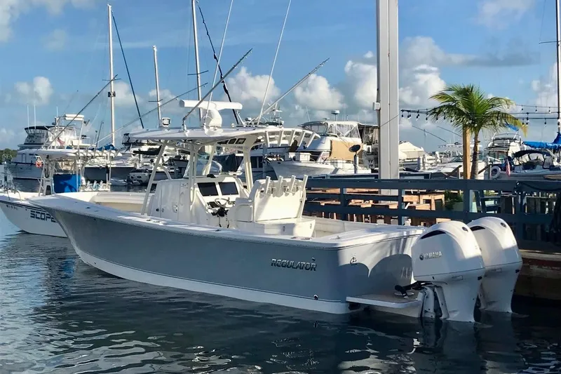 The Image of 2019 Regulator 31 boat docked at marina with twin Yamaha engines. - 0