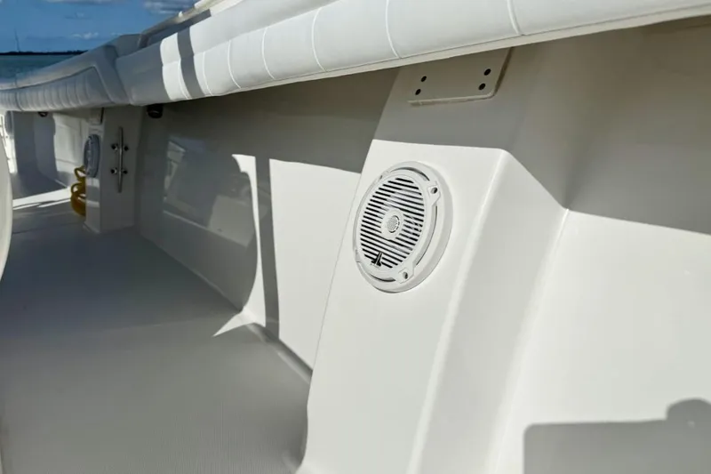 Slide: The Image of 2019 Regulator 31 boat interior with speaker and cushioned seating. - 10