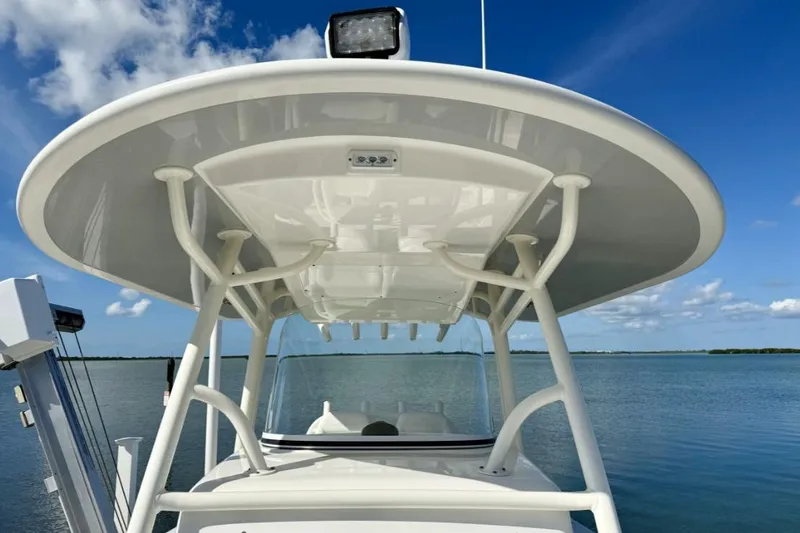 Slide: The Image of 2019 Regulator 31 boat with T-top and clear sky background. - 12