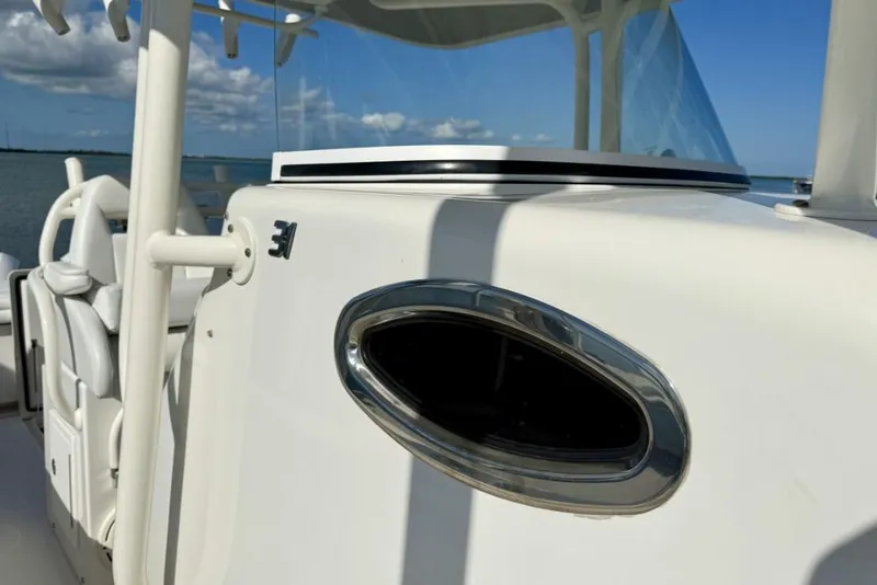Slide: The Image of 2019 Regulator 31 boat detail with sleek design and ocean backdrop. - 13