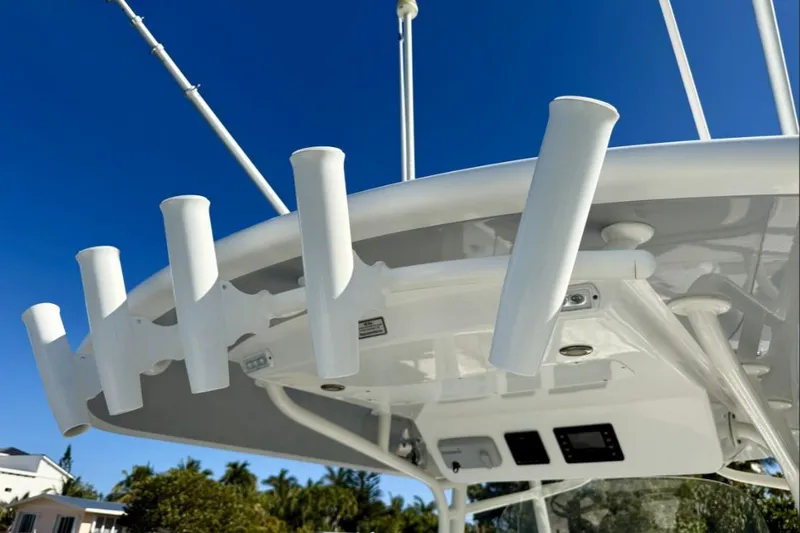 Slide: The Image of 2019 Regulator 31 boat with rod holders against a clear blue sky. - 16