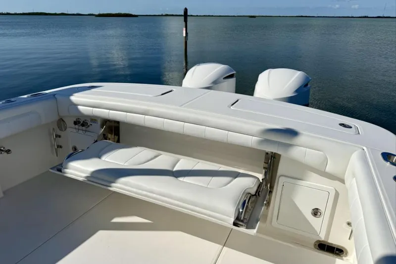 Slide: The Image of 2019 Regulator 31 boat with white seating and dual engines on calm water. - 19