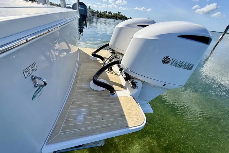 Slide: The Image of 2019 Regulator 31 boat with twin Yamaha outboard engines on a sunny day. - 26