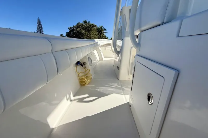 Slide: The Image of 2019 Regulator 31 boat deck with white seating and storage compartments. - 29