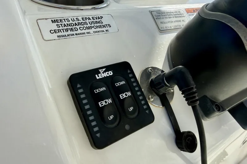 Slide: The Image of Control panel on a 2019 Regulator 31 boat with Lenco trim tab switches. - 32