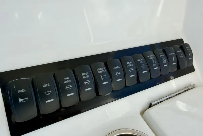 Slide: The Image of Control panel of a 2019 Regulator 31 boat with labeled switches. - 35