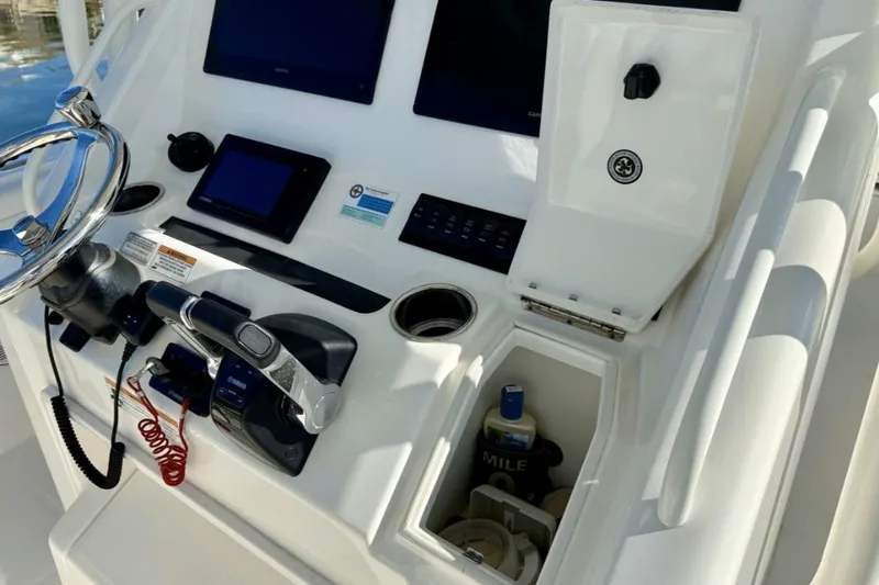 Slide: The Image of 2019 Regulator 31 boat dashboard with steering wheel and electronic controls. - 36
