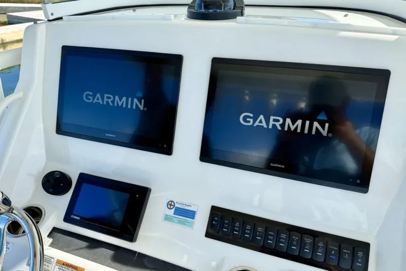 Slide: The Image of Control panel of a 2019 Regulator 31 boat with Garmin displays. - 37