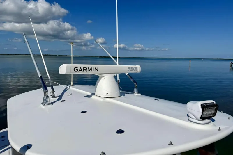 Slide: The Image of 2019 Regulator 31 boat with Garmin radar on calm water under blue sky. - 4