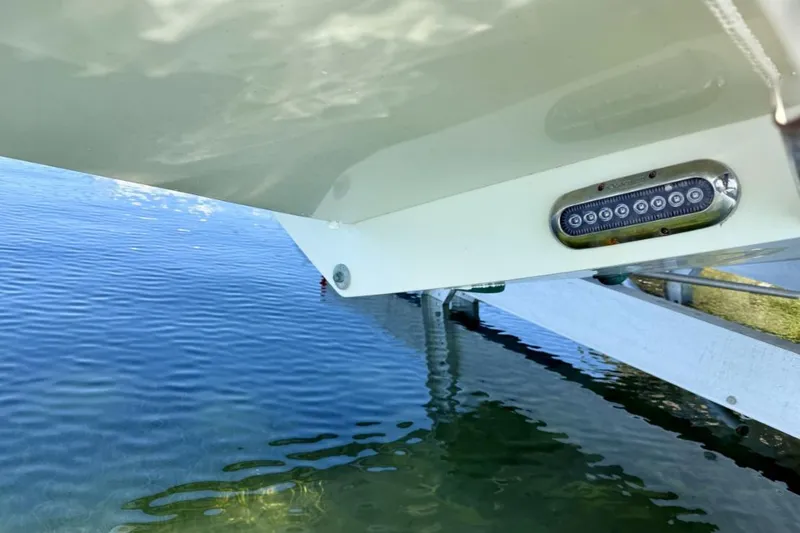 Slide: The Image of 2019 Regulator 31 boat hull with underwater LED light, reflecting on calm water. - 47