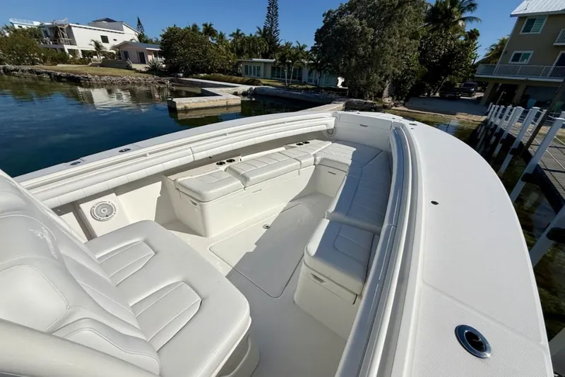 Slide: The Image of 2019 Regulator 31 boat with spacious seating, docked near waterfront homes. - 5