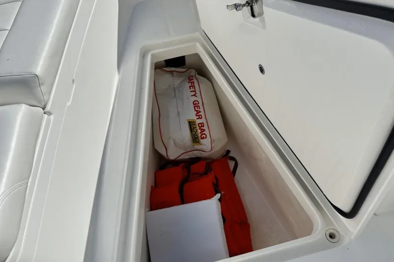 Slide: The Image of Storage compartment on 2019 Regulator 31 boat with safety gear bag and life jackets. - 9