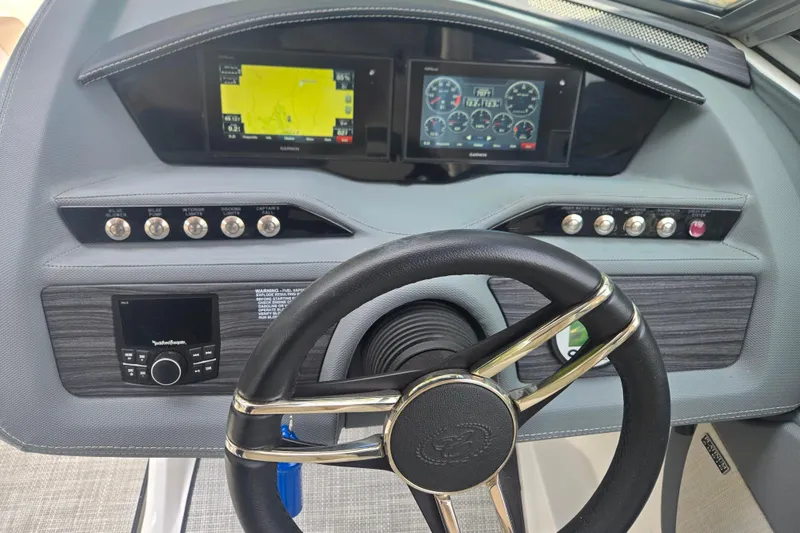 Slide: The Image of Dashboard of a 2020 Cobalt R7 Surf boat with steering wheel and control panels. - 12