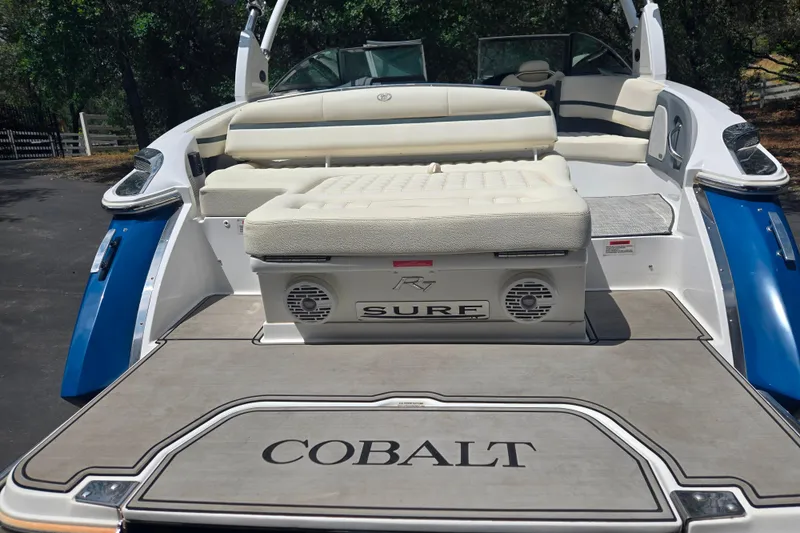 Slide: The Image of 2020 Cobalt R7 Surf boat with cushioned seating and sleek design. - 16