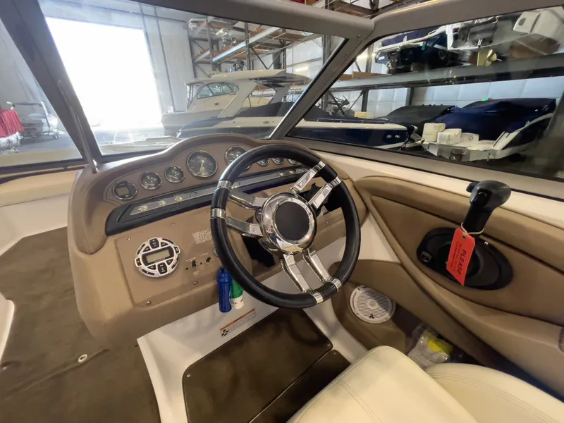 Slide: The Image of Interior view of a 2008 Cobalt 252 boat cockpit with steering wheel. - 7