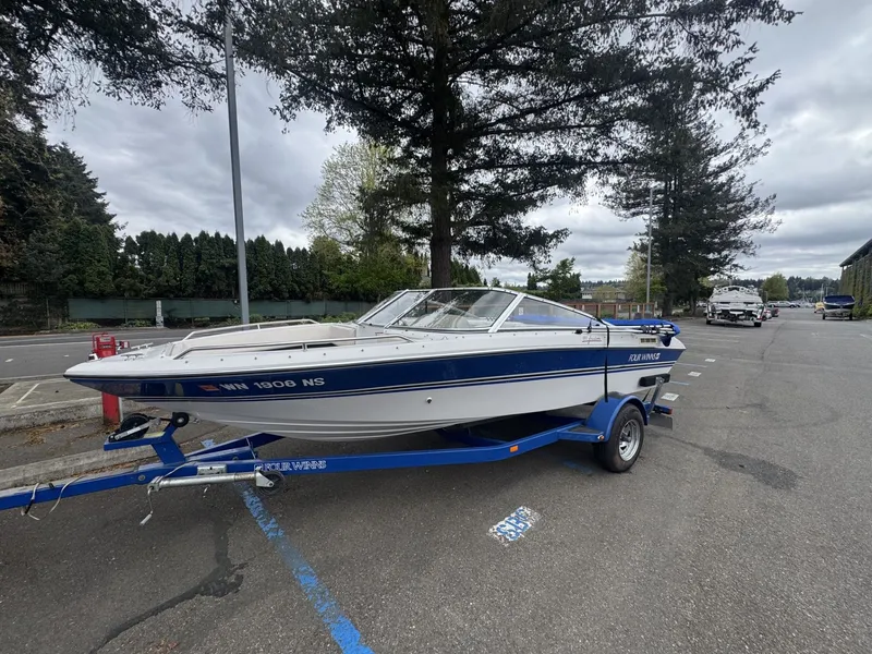 The Image of 1993 Four Winns 180 Freedom boat parked on trailer outdoors. - 1