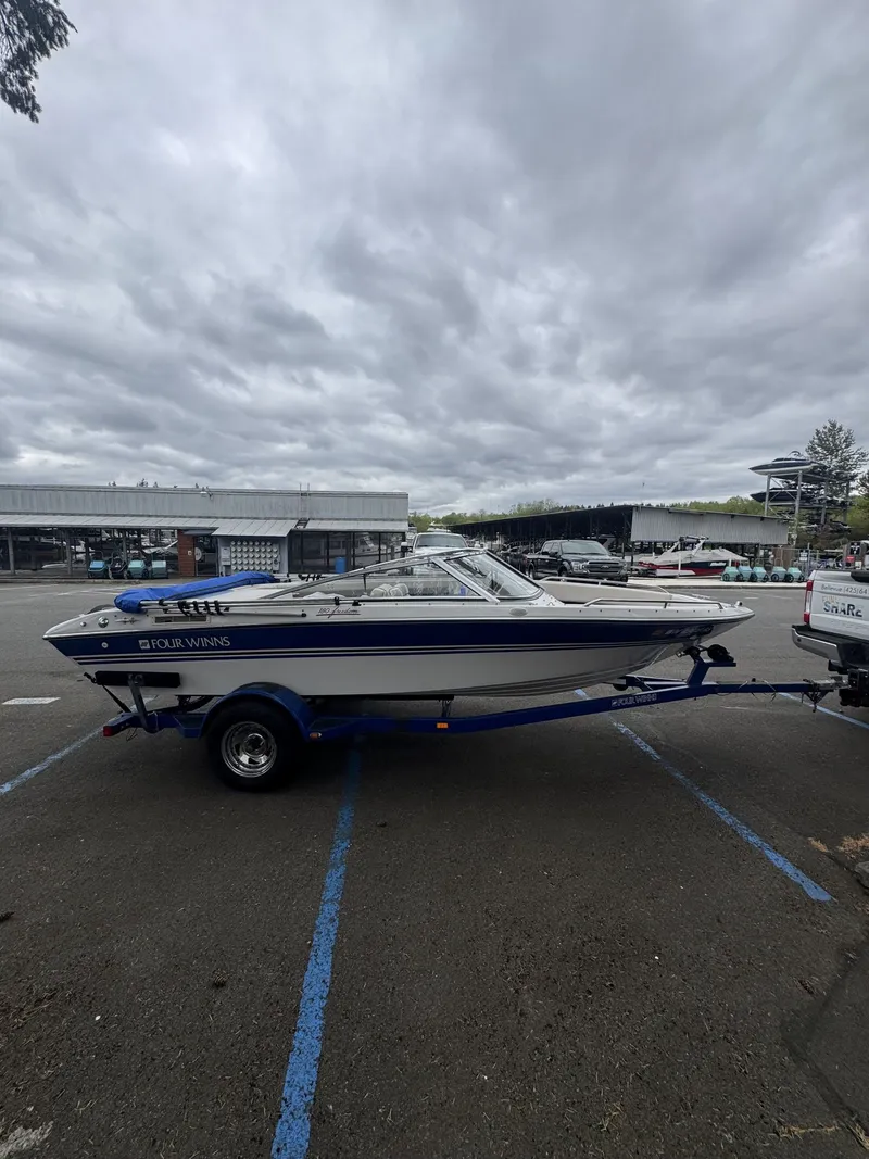 Slide: The Image of 1993 Four Winns 180 Freedom boat parked on trailer outdoors. - 2