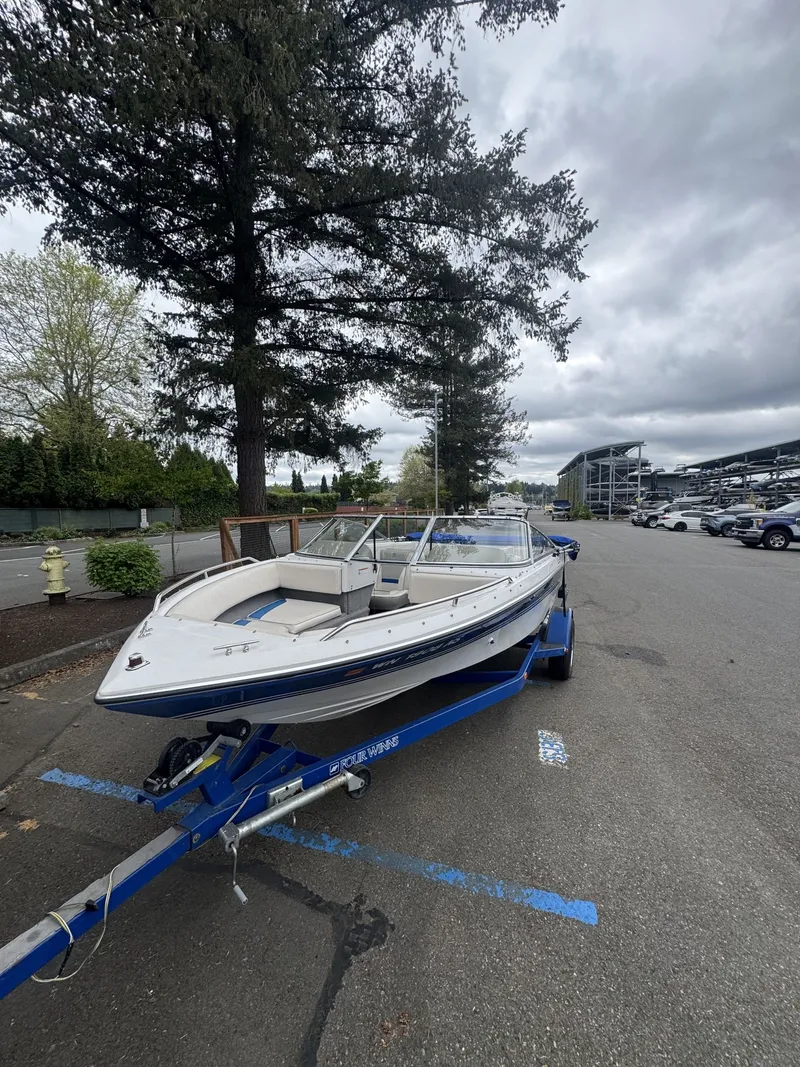 Slide: The Image of 1993 Four Winns 180 Freedom boat parked on trailer. - 3