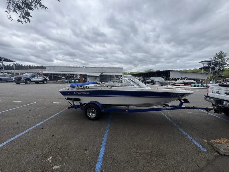 Slide: The Image of 1993 Four Winns 180 Freedom boat parked on trailer outdoors. - 5