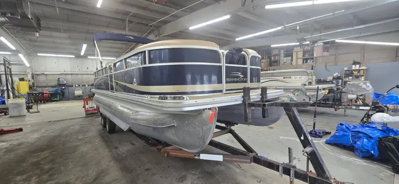 Slide: The Image of 2010 Bennington 2274GLi pontoon boat in a workshop. - 3