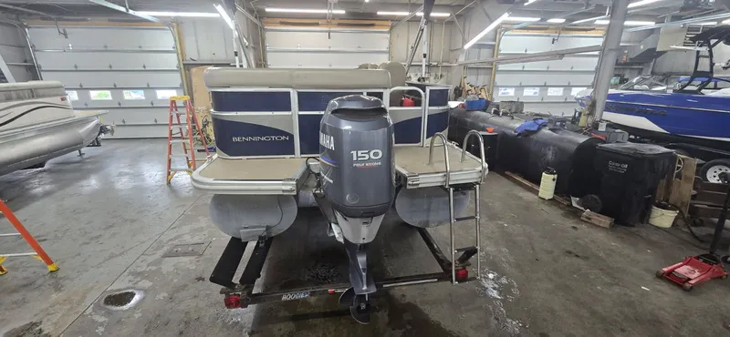 Slide: The Image of 2010 Bennington 2274GLi pontoon boat in workshop with Yamaha 150 engine. - 6