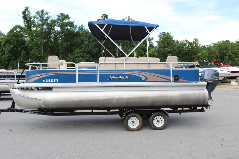 The Image of 2013 Godfrey SW 2286 FC pontoon boat with blue canopy on trailer. - 1