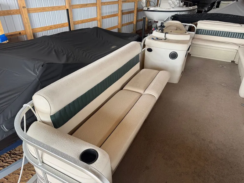 Slide: The Image of 2002 Premier L208 Leisure pontoon boat with seating area in storage shed. - 16