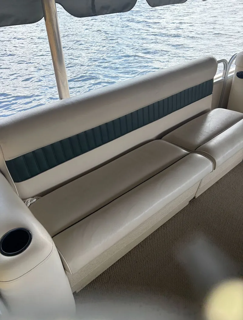 Slide: The Image of Premier L208 Leisure 2002 boat seating by the water. - 22