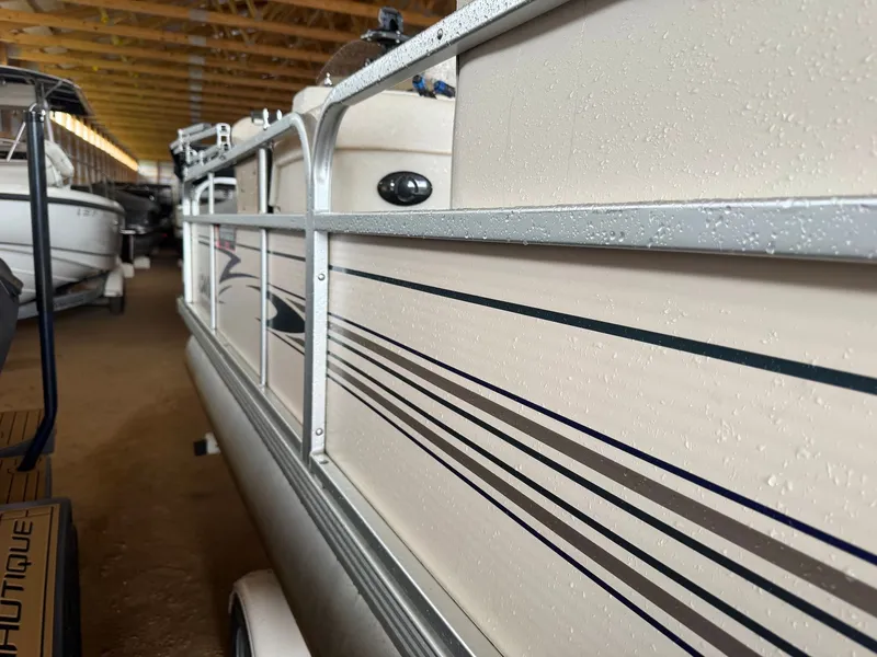 Slide: The Image of Premier L208 Leisure 2002 pontoon boat in storage facility. - 5