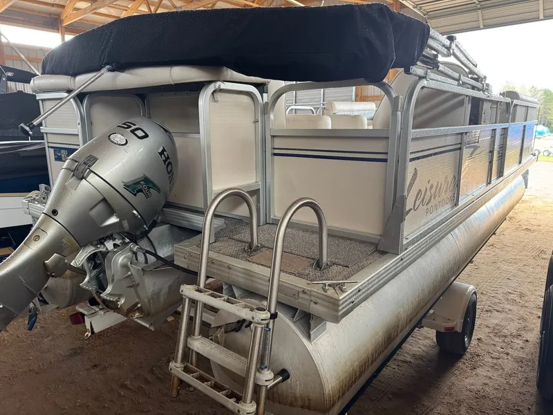 Slide: The Image of 2002 Premier L208 Leisure pontoon boat with Honda motor in storage shed. - 9