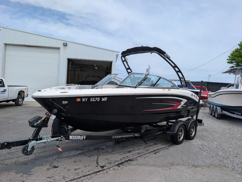 The Image of 2020 Chaparral SSi 210 boat on trailer in front of garage. - 1