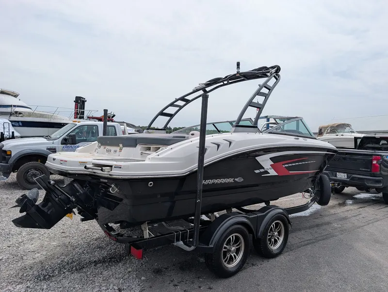 Slide: The Image of 2020 Chaparral SSi 210 boat parked on a trailer outdoors. - 3