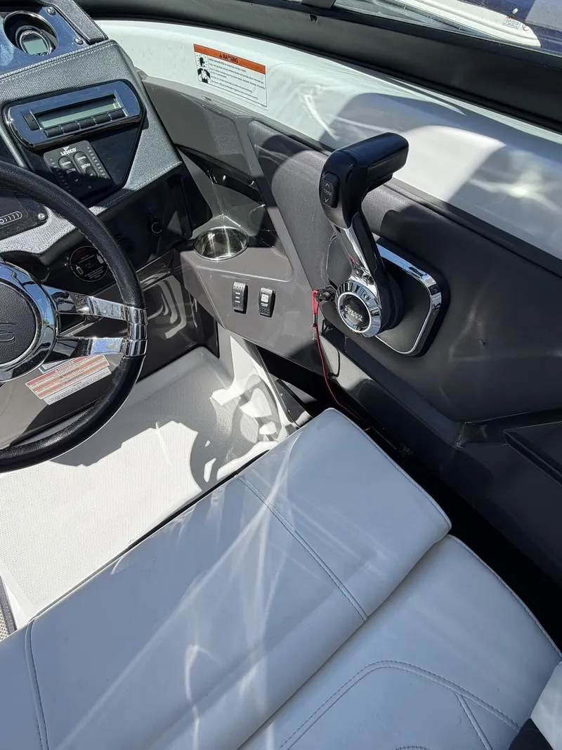 Slide: The Image of Interior of a 2018 Monterey SS 298SS boat with steering wheel and throttle. - 11