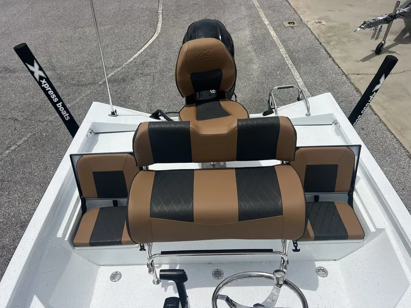 Slide: The Image of 2026 Xpress H20B Bay boat with brown and black seating. - 5